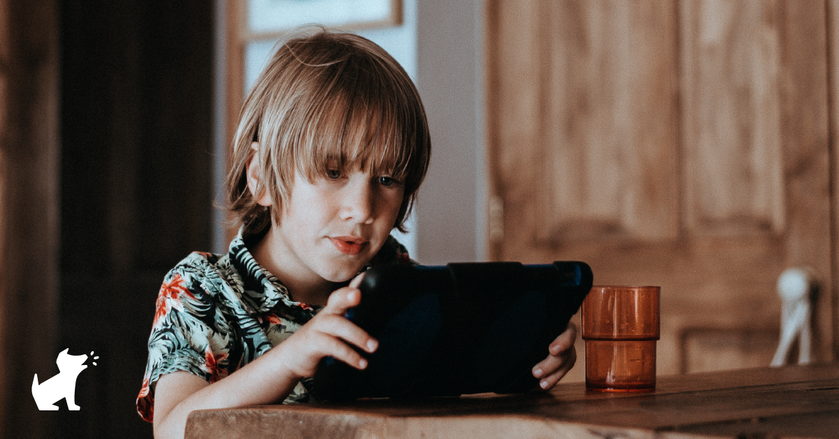 A photo of a child looking at a tablet screen