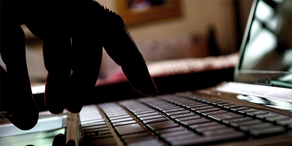 man typing on keyboard