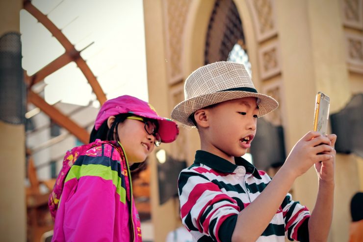 2 children using a phone